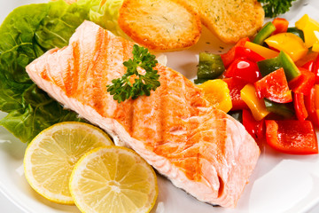 Grilled salmon and vegetables on white background 