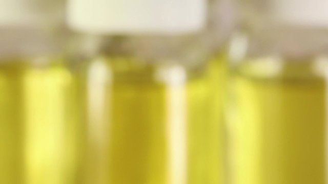 Rotating glass bottles with yellow liquid
