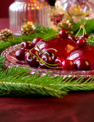 Christmas dessert - red berries jelly with cherries, cranberries and christmas tweeg