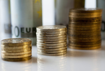 Coins columns with paper money background