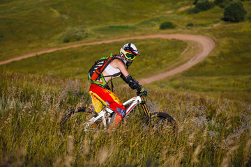 Naklejka premium Extreme sports - young woman with downhill bike