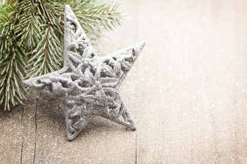 Christmas decoration with fir branches on the wood background.