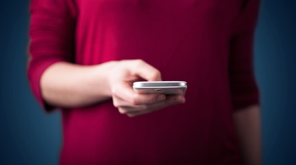 Young woman holding smarthphone in hand