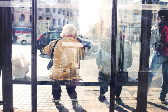 People Waiting For The Bus At The Bus Stop