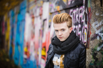 Naklejka premium Fashion male portrait on graffiti wall