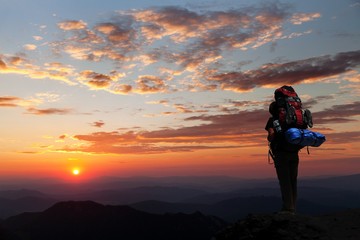view of man on mountains with big rucksack on back