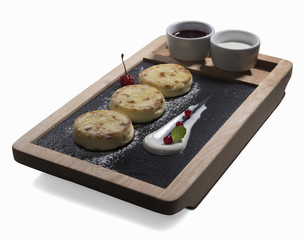 cottage cheese pancakes syrniki with sour cream isolated on white