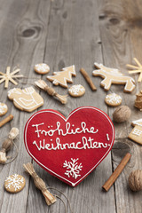 Fototapeta na wymiar Red Heart shaped Christmas gingerbread written in German