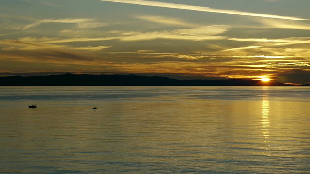 Sunset on sea at with small boats timelapse