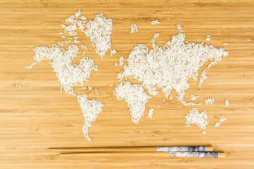 map of the world made of white rice with two bamboo sticks