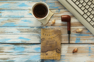 Creative business concept - keyboard, cup of coffee, smoking pipe and notebook