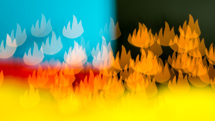 flames are everywhere, bokeh made of blurred lights in the form of flames on multicolored background, illusion of  fire