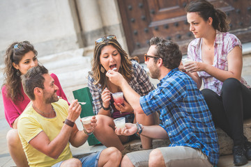 Tourists eating slush, talking and looking each other