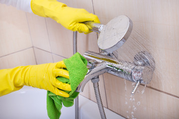 Woman cleaning bathtub