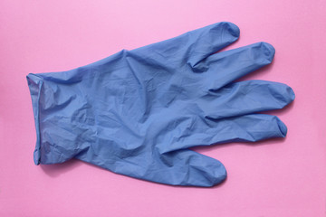 Sterile surgical glove on pink background