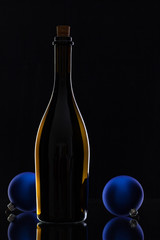 The bottle of red wine and Christmas decoration