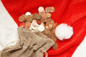 Obraz na płótnie Canvas coins on the santa hat