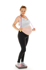 Fototapeta na wymiar Sports pregnant woman with scales.