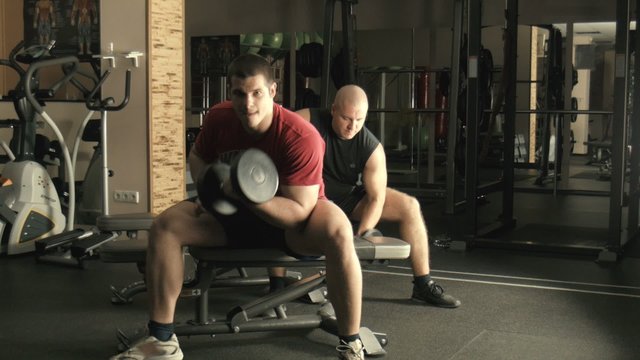 Two men train in a gym