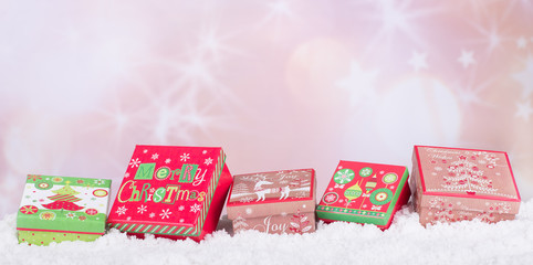 Holiday Gift Boxes on Snow and Bright Abstract Background