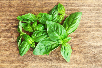 Green fresh basil on wooden background