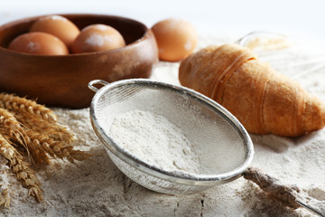 Preparing croissant on white flour background