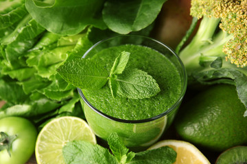 Green healthy juice with fruits and vegetables close up