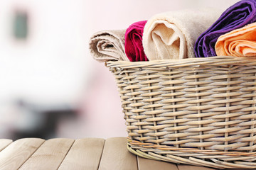 Obraz premium Colorful towels in basket on bright background