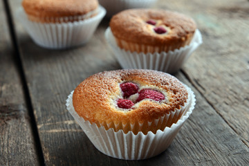 Delicious cupcake with berries on wooden table close up