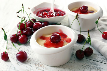 Tasty pudding with cherries on table close up