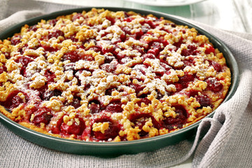 Tasty homemade pie with cherries on table close up