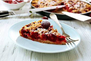 Tasty homemade pie with cherries on table close up