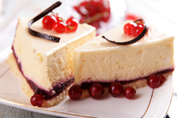 Tasty cheesecake with berries on table close up