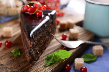 Tasty chocolate cake with berries on table close up