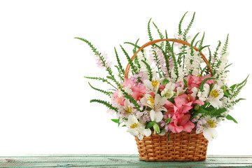 Beautiful floral arrangement in basket isolated on white