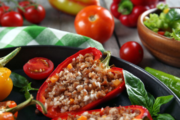 Stuffed peppers with vegetables on table close up