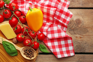 Pasta spaghetti with tomatoes, cheese and basil on rustic wooden  background