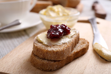 Fresh toast with butter and jam on table close up