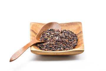 Raw of Black Jasmine Rice on the wood cup with wooden spoon.
