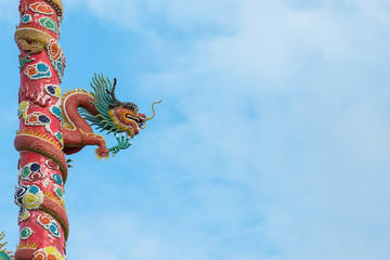 Naklejka premium Red dragon statues on red pole in front of Naja Chinese Temple,