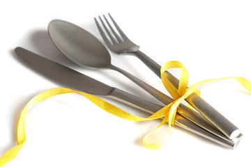 Cutlery tied with ribbon on light background