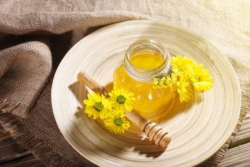 Obraz na płótnie Canvas Honey, dipper and honeycomb on closeup, top view