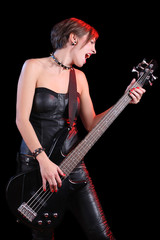 Sexy girl in leather clothes with bass guitar. punk rocker
