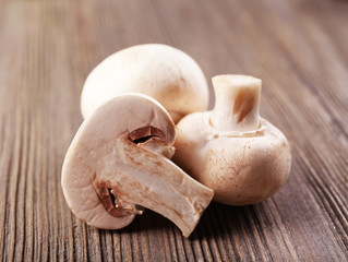 Champignon mushrooms on grey wooden background