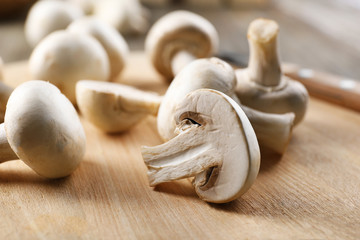Champignon mushrooms on wooden background