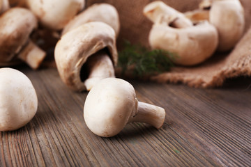 Champignon mushrooms on wooden background