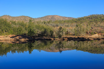 Fototapeta na wymiar Morning light on a calm tropical river in North Queensland.