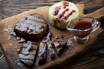 Grilled marbled beef steaks with mashed potatoes, studio shot