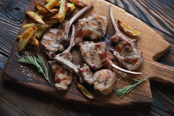Grilled bobby veal rack steaks with french fries, close-up