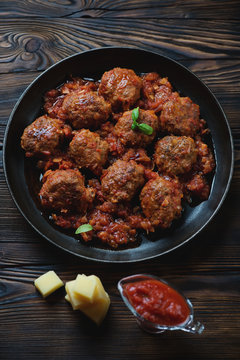 Frying pan with meatballs in tomato sauce, high angle view